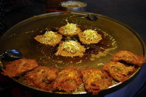 Fried shells in a large pan that are being finished are appetizing colors, wh Stock Photos