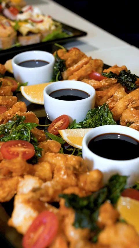 Fried shrimp appetizers with dipping sauces at conference catering buffet Stock Footage 335694834