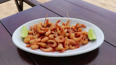 Fried shrimp on the table in front of the sea in Bahia Brazil Stock Footage 172013814