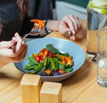 Fried shrimps with vegetables on the table Stock Photos
