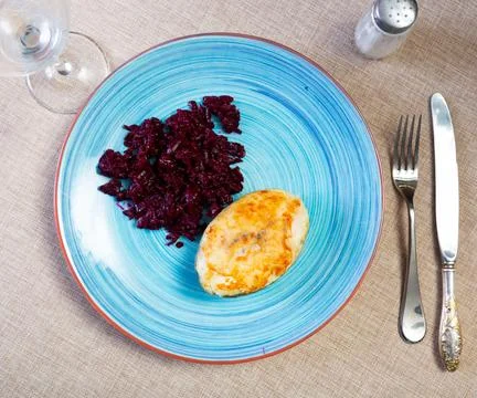 Fried slice of cod fillet served with stewed beetroot. Stock Photos