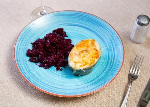 Fried slice of cod fillet served with stewed beetroot. Stock Photos