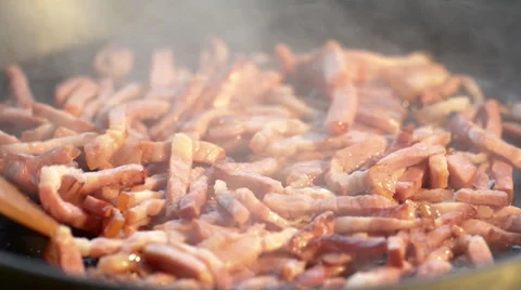 Fried sliced bacon on a hot pan Stock Footage 34281413