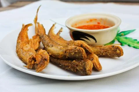 Fried small fish on the plate. Stock Photos