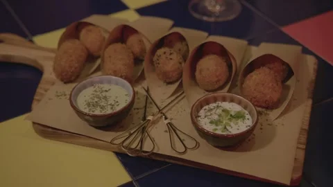 Fried Snacks and Dipping Sauces Served on Platter in Beijing Bar Setting Stock Footage 345754914
