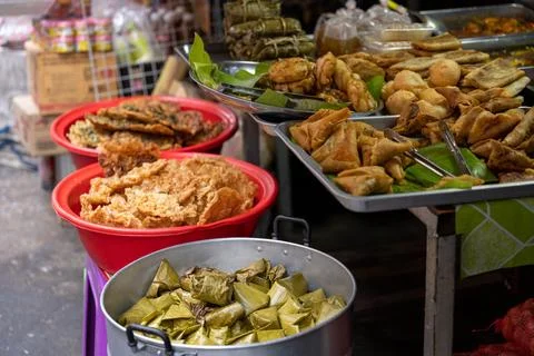 Fried snacks and leaf wrapped parcels at Bangkok market Stock Photos