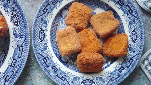 Fried snacks on a blue patterned plate Stock Footage 340863397
