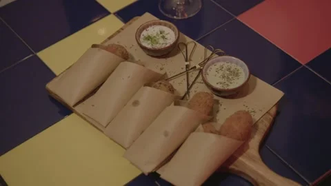 Fried Snacks with Dipping Sauces Served on Wooden Board in Beijing Bar Setting Stock Footage 345754874