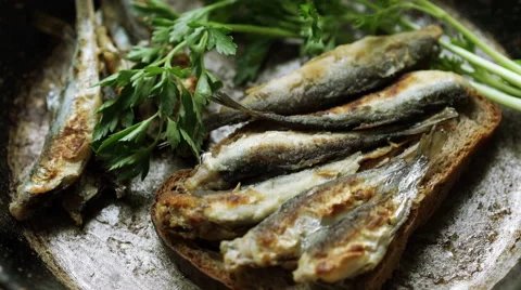Fried sprat fish with bread and parsley Stock Footage 67675503