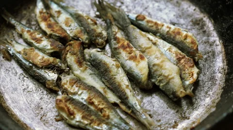 Fried sprat fish with bread and parsley Stock Footage 67675506