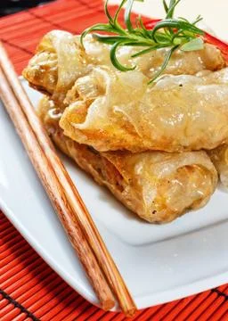 Fried spring rolls on red bamboo mat Stock Photos