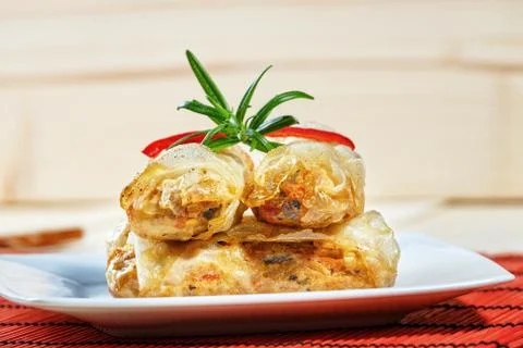 Fried spring rolls on red bamboo mat Stock Photos