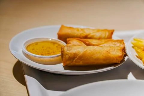 Fried spring rolls with red chilli sauce, tomato and lettuce Stock Photos