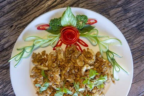 Fried squid or octopus with garlic on plate Stock Photos