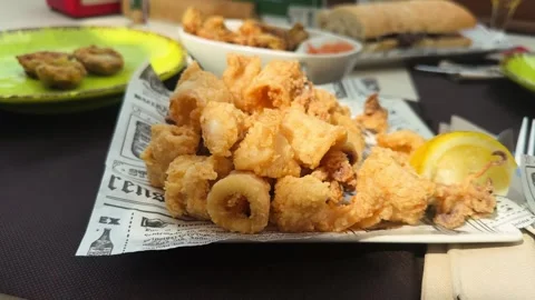 Fried squid, popular Mediterranean dish, consisting of squid rings dipped in Stock Footage 312340873