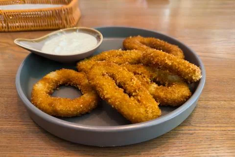 Fried squid rings in breading, close-up in selective focus Stock Photos