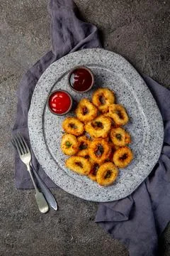 Fried squid rings on gray stone plate with sauces. Gray concrete background Stock Photos