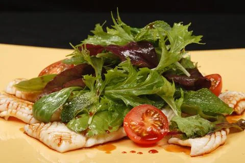 Fried squid with vegetable salad Stock Photos