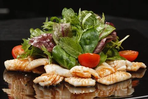 Fried squid with vegetable salad Stock Photos