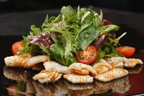 Fried squid with vegetable salad Foto stock