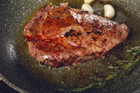 Fried steak, beef steak, rib eye steak, in a frying pan, top view, no people Stock Photos
