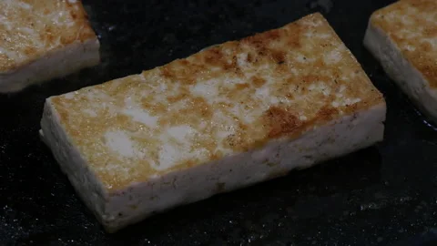 Fried strong fermented bean curd tofu on a pan Stock Footage 162641193