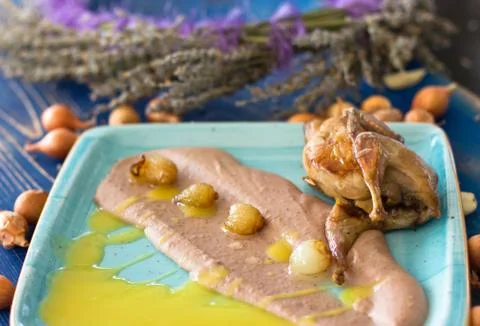 Fried stuffed quail with mashed chestnuts and small onions Stock Photos