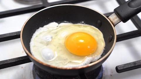 Fried sunny side up egg on a pan Stock Footage 126077306