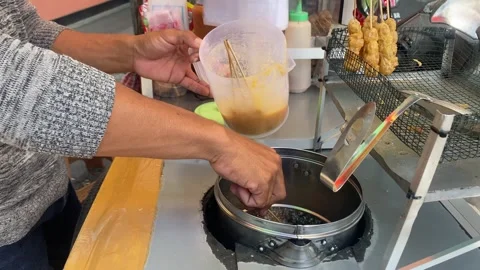 Fried tapioca dough with egg – Indonesian street food Stock Footage 246724714