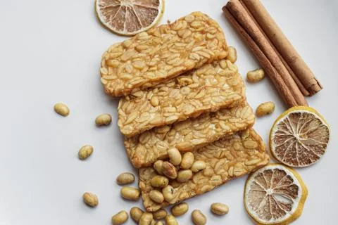 Fried tempe or fermented soybean cake on a white plate Stock Photos