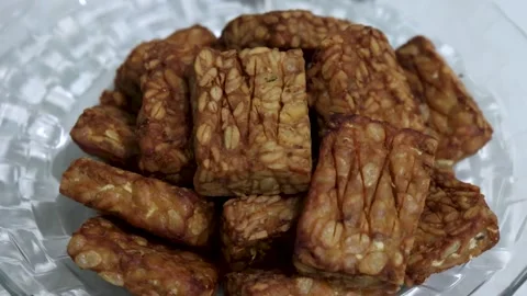 Fried tempeh in oil is served as a side dish in developing countries. Stock Footage 300853143
