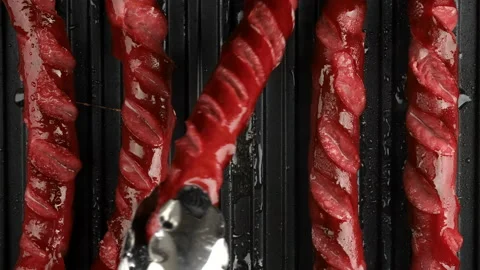 Fried thin sausages on grill top view Stock Footage 137932315