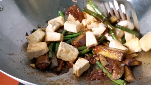 Fried Tofu with Long String Beans and Eggplant in a Wok Stock Footage 234882280