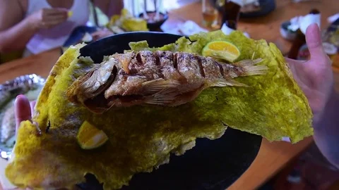 Fried Trout Served On Flattened Fried Plantain  Stock Footage 73610667