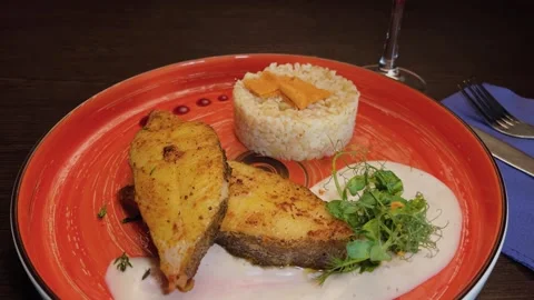 Fried trout steaks with rice on a beautiful plate 库存影片 306157808