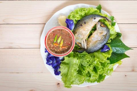 Fried two mackerels with vegetable on white Stock Photos