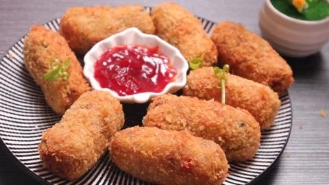 Fried vegetables nuggets dipping in sauce and eating  Stock Footage 328723756