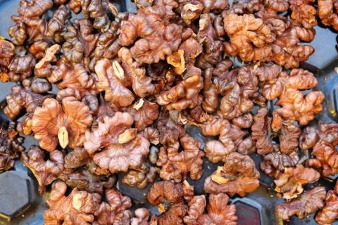 Fried walnuts top view. Toasted nuts from the oven. Stock Photos