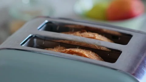 Fried wheat bread pops out of a modern toaster, close-up. Stock Footage 277822308