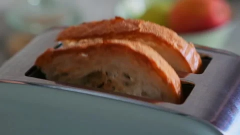 Fried wheat bread pops out of a modern toaster, close-up. Stock Footage 278648958