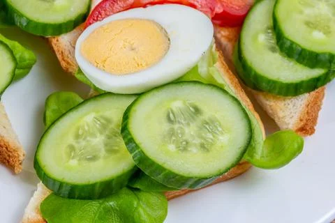 Fried white bread toasts with vegetable and egg slices on a plate Stock-Fotos