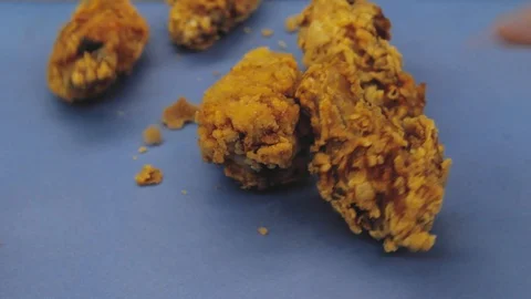 Fried wings fall on the table close-up. Stock Footage 125653738