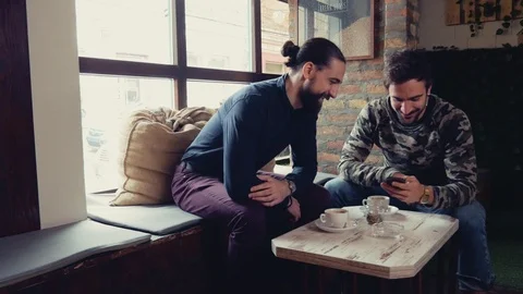 Friend smiling and talking while looking at mobile phone Stock Footage 95900714