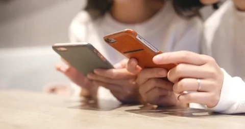 Friend using cellphone together in restaurant Stock Footage 84401041