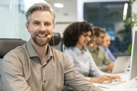 Friendly and helpful customer service support specialists in work Stock Photos