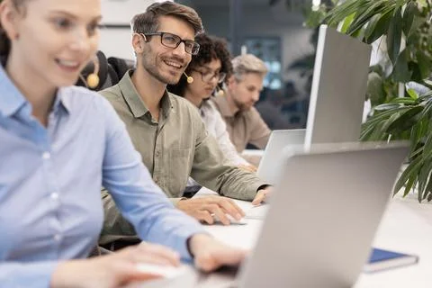 Friendly and helpful customer service support specialists in work Stock Photos
