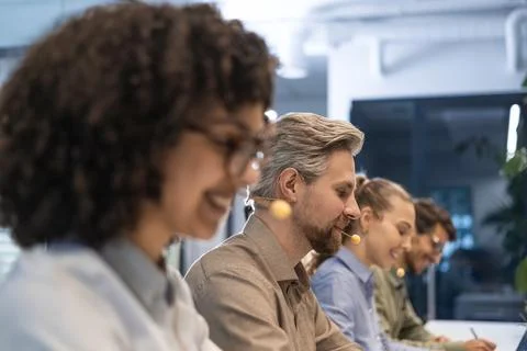 Friendly and helpful customer service support specialists in work Stock Photos