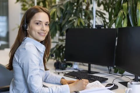 Friendly and helpful customer service support specialists in work Stock Photos