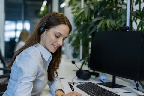 Friendly and helpful customer service support specialists in work Stock Photos