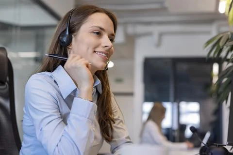 Friendly and helpful customer service support specialists in work Stock Photos